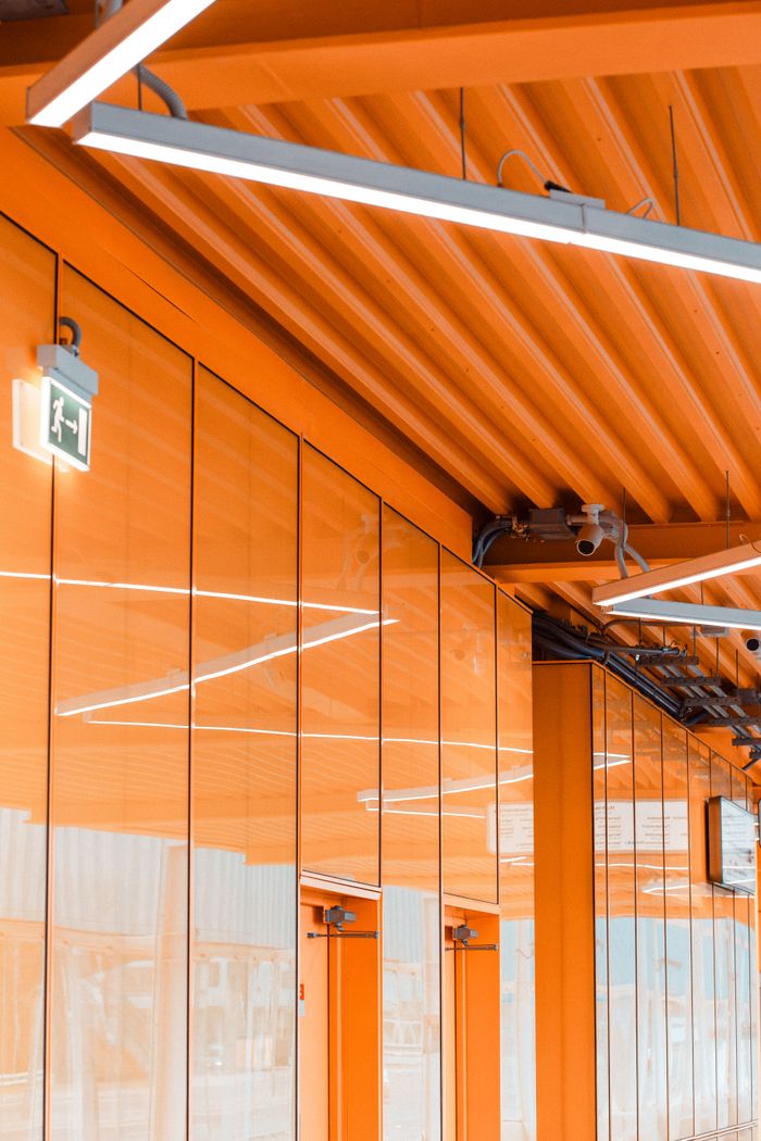 Hizmetlerimiz Vibrant orange hallway with geometric patterns and security features in Moscow, Russia.